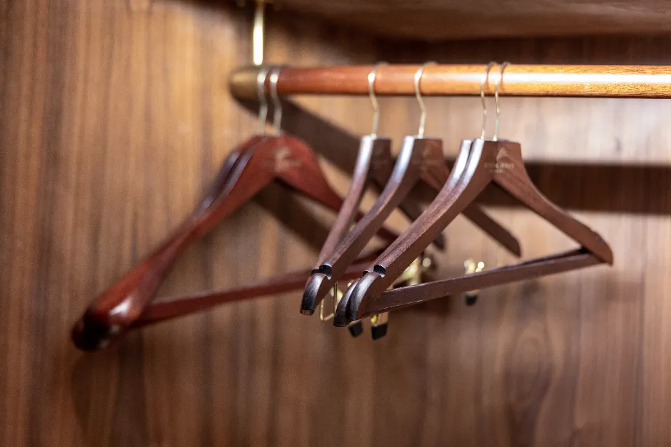 Wooden hangers on a closet rod