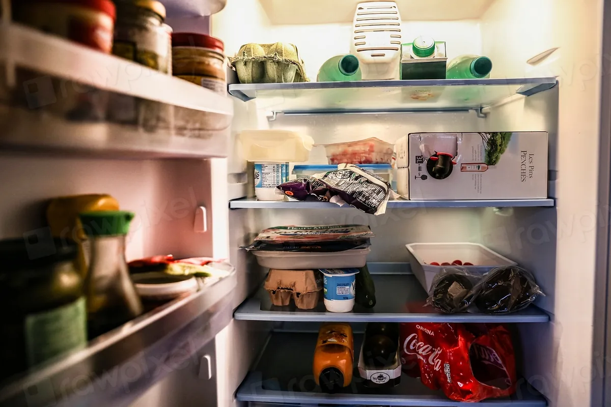Open refrigerator stocked with everyday food
