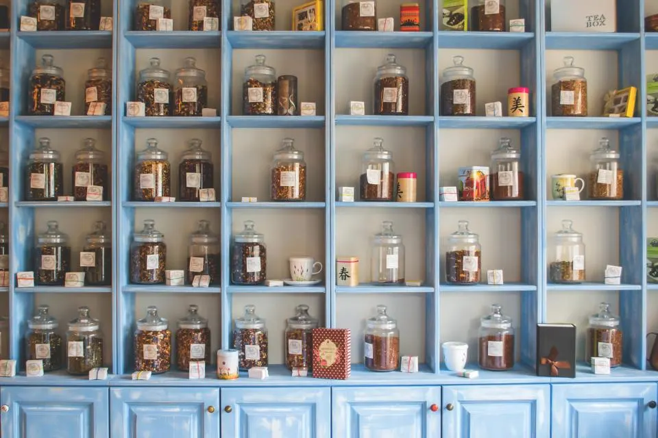 Blue open shelving filled with glass jars