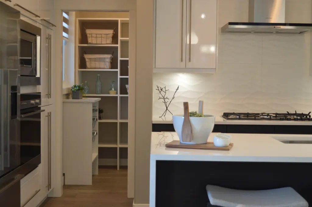 Bright kitchen with a white pantry cabinet and baskets on shelves
