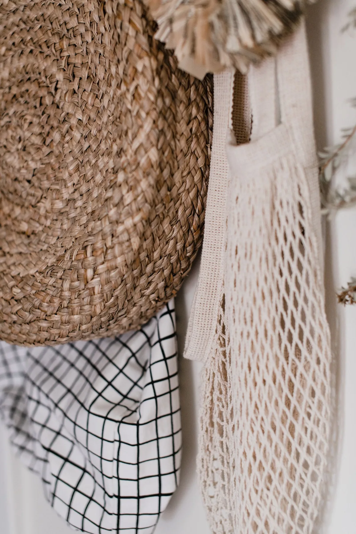 Woven basket and hat hanging on a wall hook